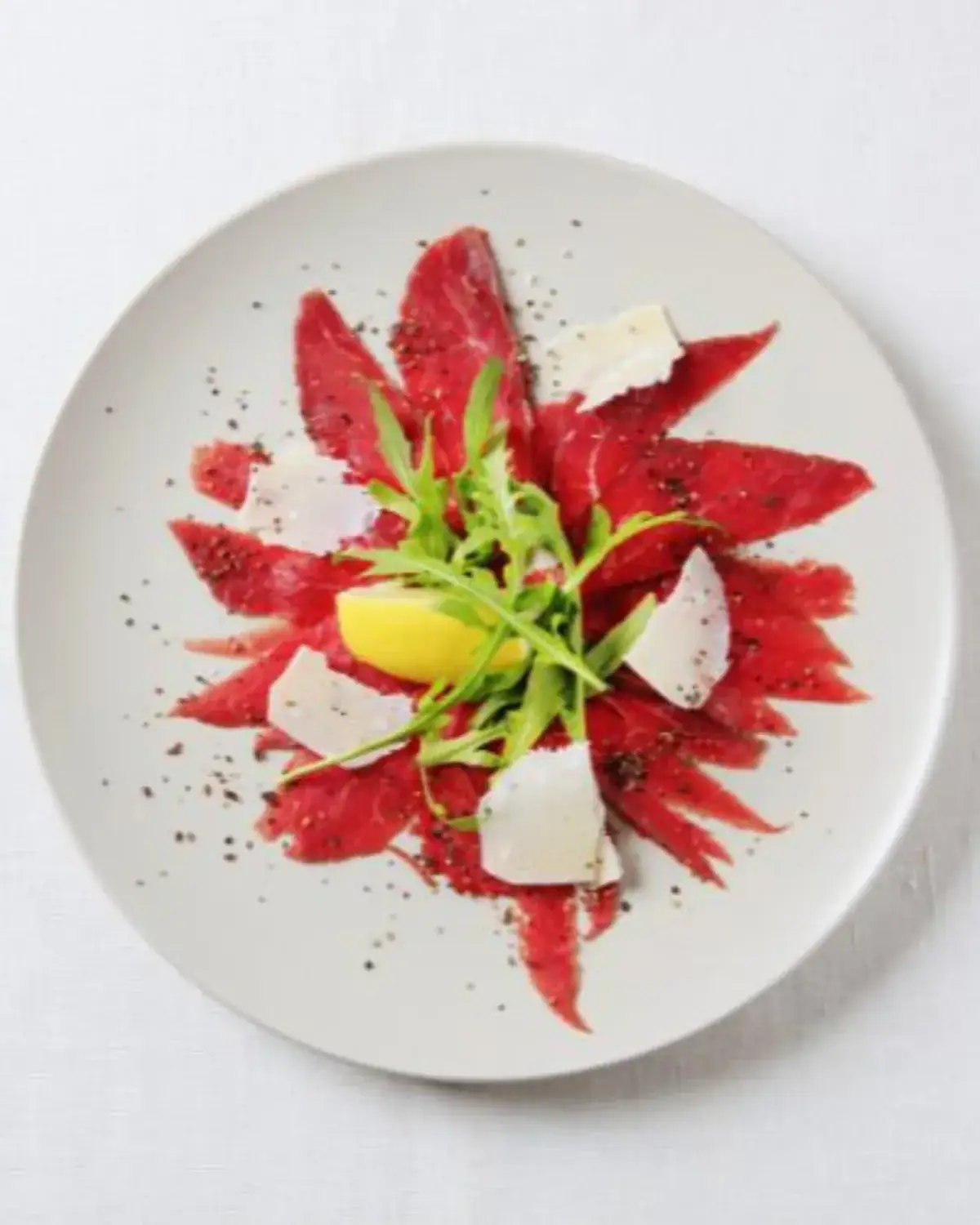 Carpaccio de bœuf maturé, parmesan affiné et roquette — cuisine d'exception chef à domicile