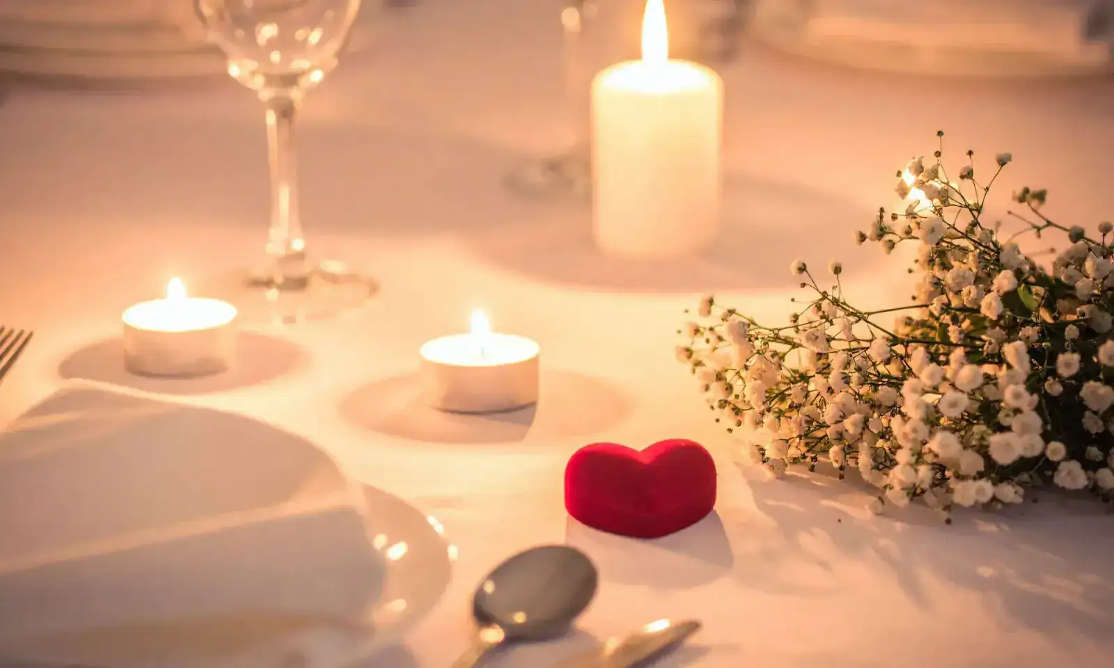 Table intimiste dressée avec bougies pour un dîner romantique privé
